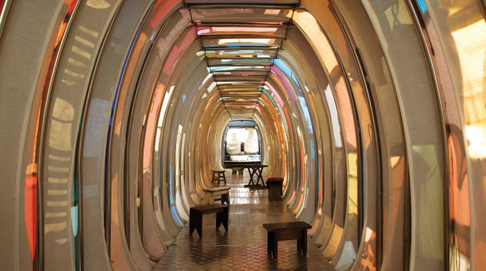 Yin Xiuzhen, Collective Subconscious, 2007, minibus, stainless steel, used clothes, stools, audio, 38-feet long. Collection of the artist.