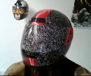 Johnny Tragedy avoids injury from potentially harmful mishaps while at the same time concealing his second identity by wearing a piece of his new work.