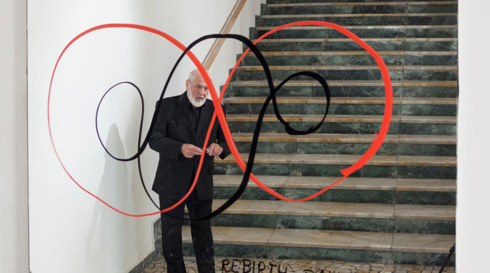Michaelangelo Pistoletto and his symbol for the Third Paradise. Image courtesy of Galleria Continua.