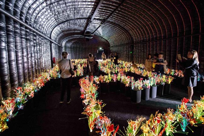 Visitors walk around the installation 'Giardino dell'Eden' by Portuguese artist Joana Vasconcelos at the Swatch espace. The Venice Biennale entitled 'All the World's Futures' runs May 9 to November 22. (Maciej Kulczynski/EPA)