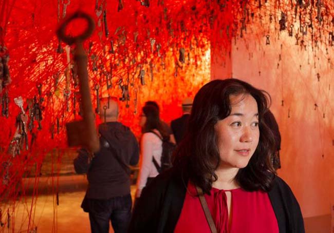 Japanese artist Chiharu Shiota poses with her installation 'The Key in the Hand' inside the Japan Pavilion at the 56th Biennale of Arts in Venice, Wednesday, May 6, 2015. Photo: Domenico Stinellis, AP