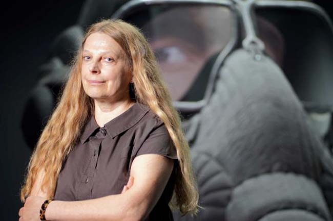 Russian artist Irina Nakhova poses next to a futuristic sculpture of a head of a pilot inside her installation 'The Green Pavilion' on display at the Russian pavilion at the 2015 Biennale of Arts in Venice, Italy, Wednesday, May 6, 2015. Photo: Domenico Stinellis, AP