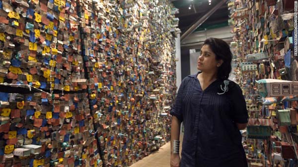 Indian artist Hema Upadhyay poses in front of her "Think Left, Think Right, Think Low, Think Tight" installation at the Paris's Pompidou Centre on May 23, 2011.