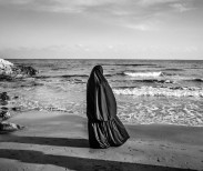 Syrian woman looks at the sea in Kizkalesi, around 60 KM west of Mersin, Turkey, while hoping to be embarked soon on a ship headed to Europe, January 29, 2015. 
As the Syrian civil war continues with no end in sight thousands of Syrian refugees arrive each year to the turkish coasts near Mersin, turning to human smuggling operations as a way to reach Europe. One of the smugglers operating out of the port of Mersin, when interviewed, reported that 6,000 $ are required, per person, to get an illegal passage to Europe on board of old freighters. According to UNHCR more than 3,000 refugees and migrants drowned in the Mediterranean in 2014 fleeing conflict-torn regions, and more than 3,700 died in the same way in 2015.