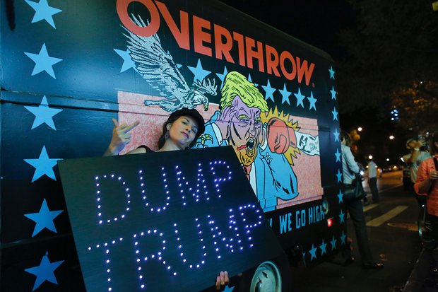 A woman poses next to the Knockout Trump Truck outside the IFC Theater, ahead of the premiere of Michael Moore in TrumpLand. Photograph: Kena Betancur/AFP/Getty Images