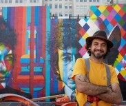 International mural artist, Eduardo Kobra, stands in front of his mural of Bob Dylan in downtown Minneapolis.