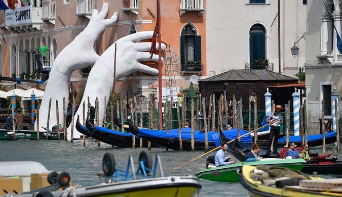 Lorenzo Quinn’s installation, Support, at the Ca’Sagredo hotel, Venice. Photograph: Zsolt Czegledi/EPA